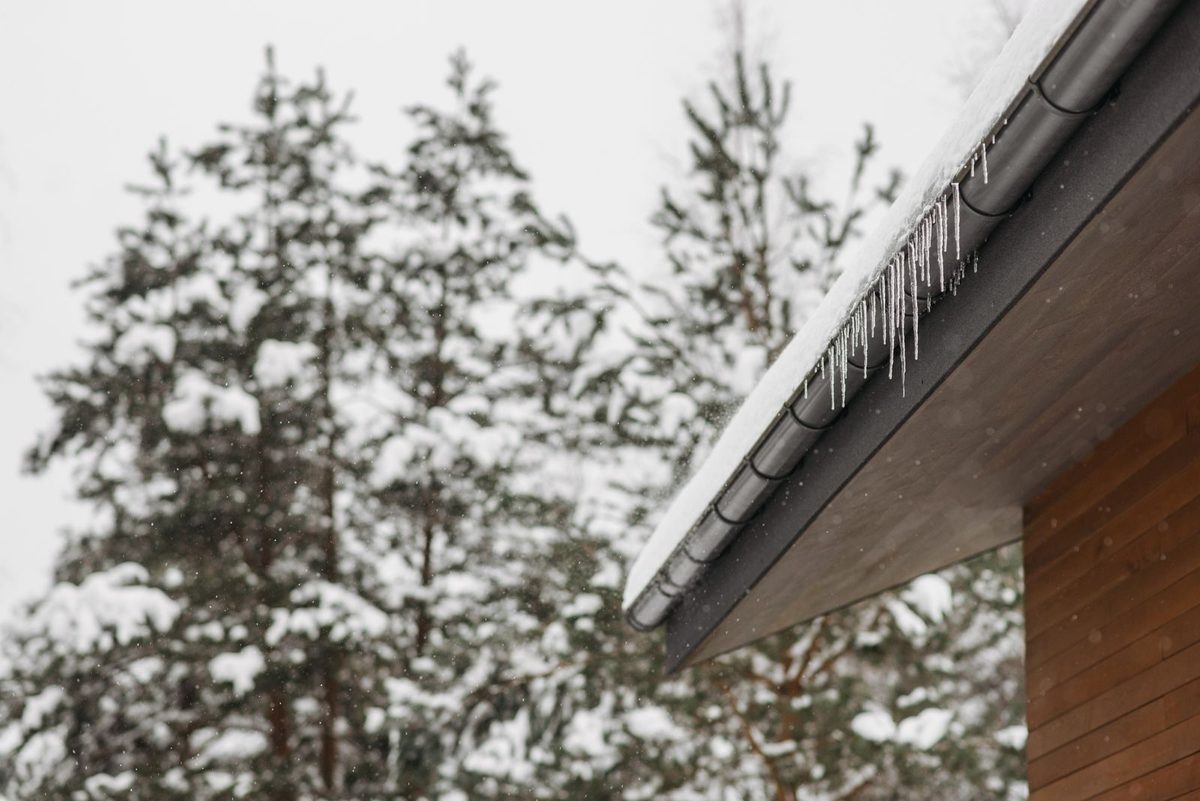 Icicles on a snow-covered roof after a North Texas freeze in Plano, TX