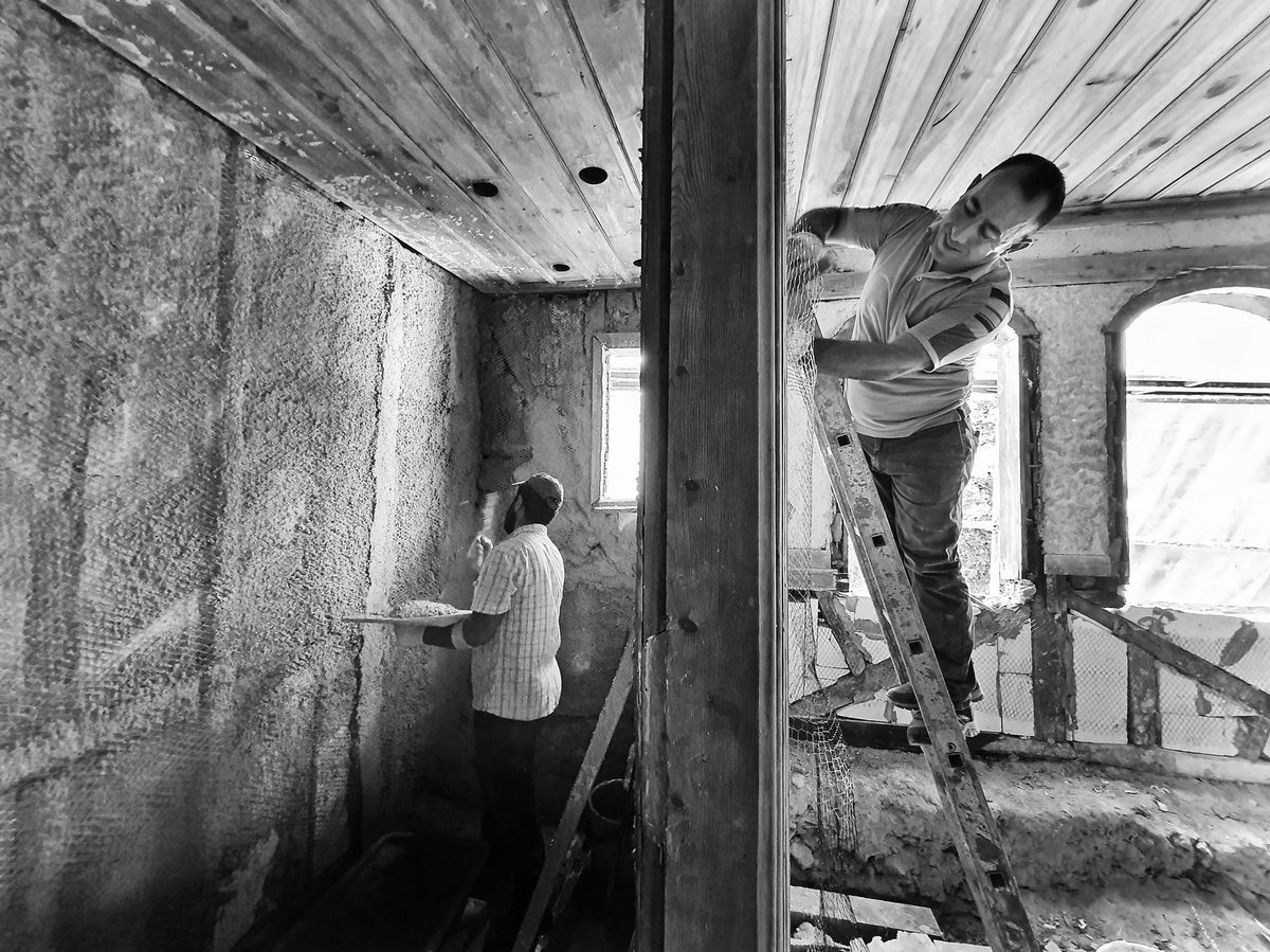 Workers renovating a room during water damage reconstruction in Plano, TX