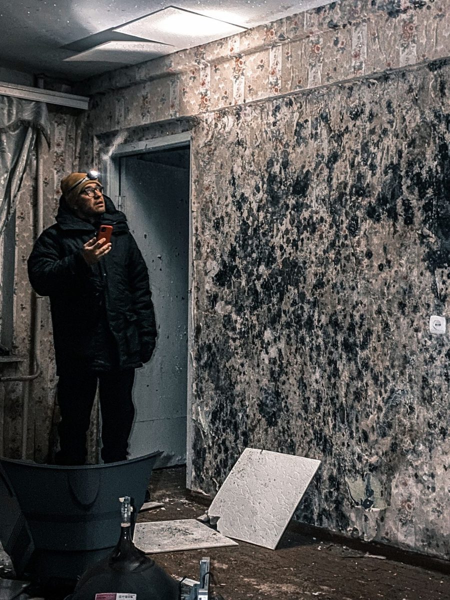 Inspector examining mold growth on interior walls in Plano, TX